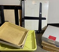 Group shot showing easel, trays, and paper boxes