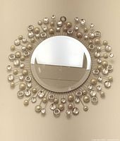 Front view of sunburst mirror hung on wall