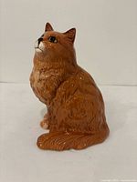 Front left profile of glazed ceramic cat figurine