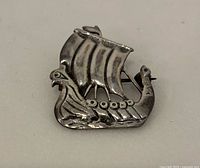 Front view of sterling silver Viking ship brooch