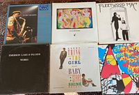 Six LP records laid out showing front jacket artwork