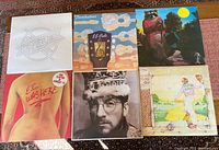 Six album covers laid out: three J.J. Cale titles, Clapton, Costello, Elton John