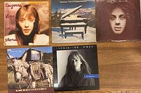 All five LP records front covers displayed on table