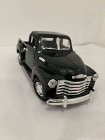 Front three-quarter view showing grille, bumper and hood detail