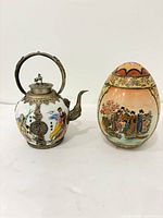 Teapot and egg ornament side by side for scale and style