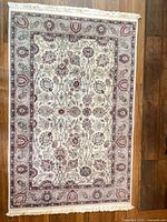 Full view of wool area rug showing overall pattern and fringe