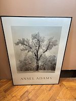 Full view of framed Ansel Adams print leaning against wall