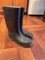 Pair of black rubber rain boots front view