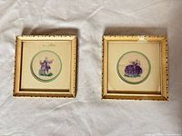 Front view of both embroidered miniatures in gilt frames