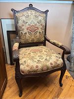 Front view of carved French Provincial armchair