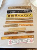 Group shot of 13 rulers laid out vertically