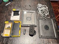 Overview of all accessories including OtterBox inserts, tablet case pieces, Belkin mount, car adapter, cables