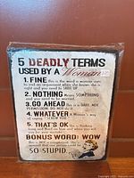 Front view of metal sign showing text and artwork