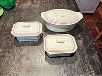 Group shot showing oval casserole and two rectangular covered dishes with lids