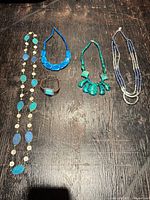 All five jewelry pieces laid out for overview