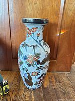 Full view of vase front showing floral and bird motif and Greek-key rim