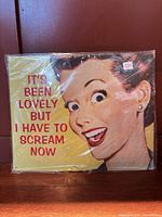 Front view of wrapped tin sign showing graphic and text