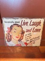 Front of tin wall plaque showing illustration and humorous text