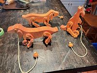 All three wooden pull toys on tabletop