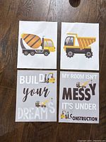All four construction-themed canvas prints laid out on floor