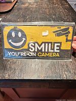 Front view of metal novelty sign sealed in plastic