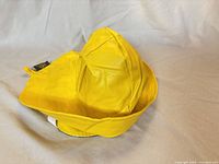 Side view of yellow Sou'Wester rain hat showing brim and crown