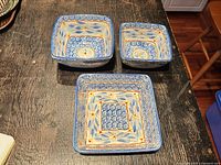 Three square Temp-tations Old World blue stoneware bowls nested on table