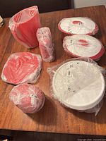 All items bagged in original plastic, grouped on table