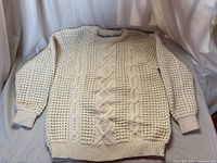 Front view of cream Aran sweater showing overall pattern