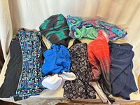 All eight swimwear pieces laid out showing variety of colors and styles