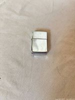 Closed polished chrome Zippo lighter front view