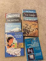 Stacks of eight hardcover books showing all titles