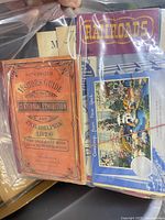 Front view of plastic bag showing Centennial Exhibition Visitor’s Guide and Railroads pamphlet