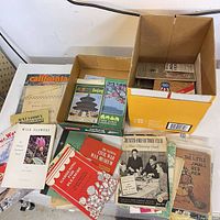 Overview of assorted pamphlets in two boxes on table