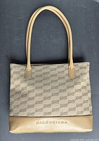 Front view showing BB monogram canvas, leather base with embossed Balenciaga logo and handles