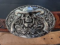 Close-up of ornate skull buckle