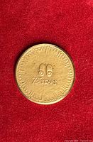 Reverse with stylized logo and 75 YEARS legend on red background