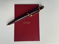 Full pen atop red passport booklet