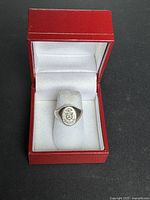 Sterling silver University of Toronto ring in open red presentation box, top view