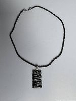 Full necklace laid flat showing chain and pendant