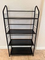 Front view of black metal 4-tier bookshelf