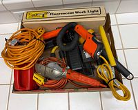 Box containing multiple work lights and cords