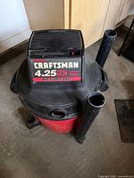 Front view of Craftsman wet/dry vac showing brand label and two extension wands