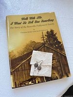 Cover of biography with earrings envelope on top