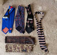 Six ties displayed; five unique designs visible