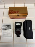 Flash unit, case, manual, and box displayed