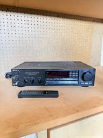 Front view of Sony STR-AV320 receiver with remote placed in front