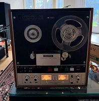 Front view showing controls, reels, meters, wood case