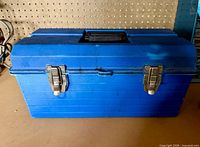Closed blue plastic toolbox front view