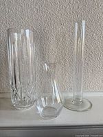 All three clear glass vases side by side